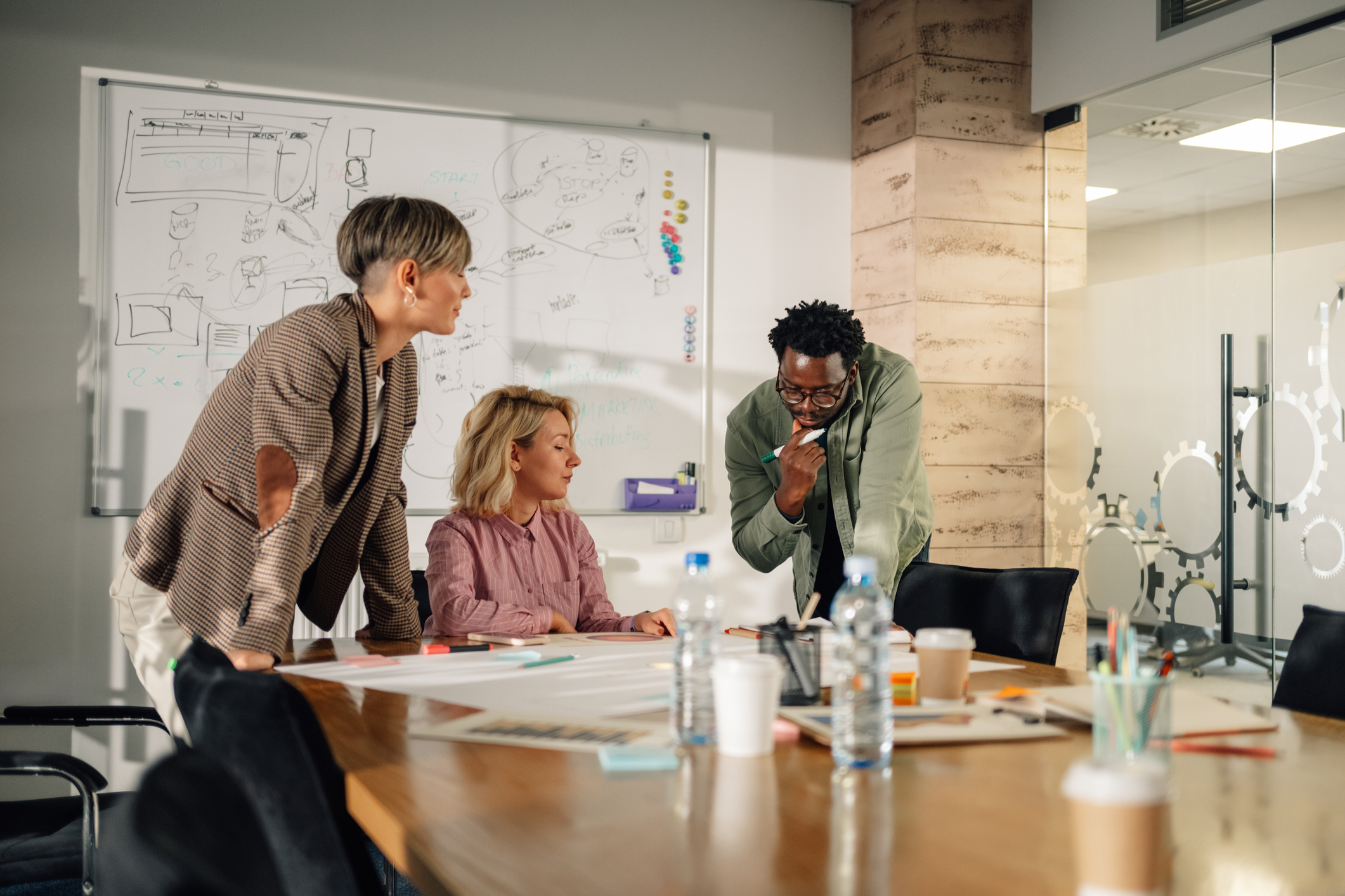 A marketing team meets around a conference table.