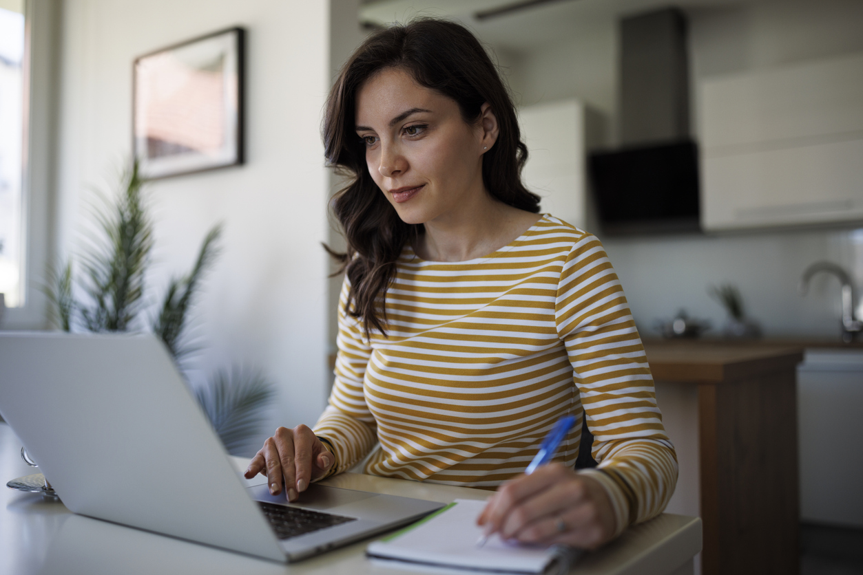 A person works on a laptop in an office. 