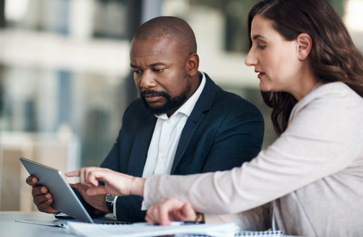 Financial examiners review financial records in an office.